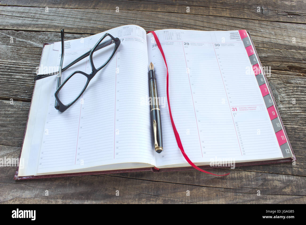 Fountain pen and personal organizer with eyeglasses Stock Photo - Alamy
