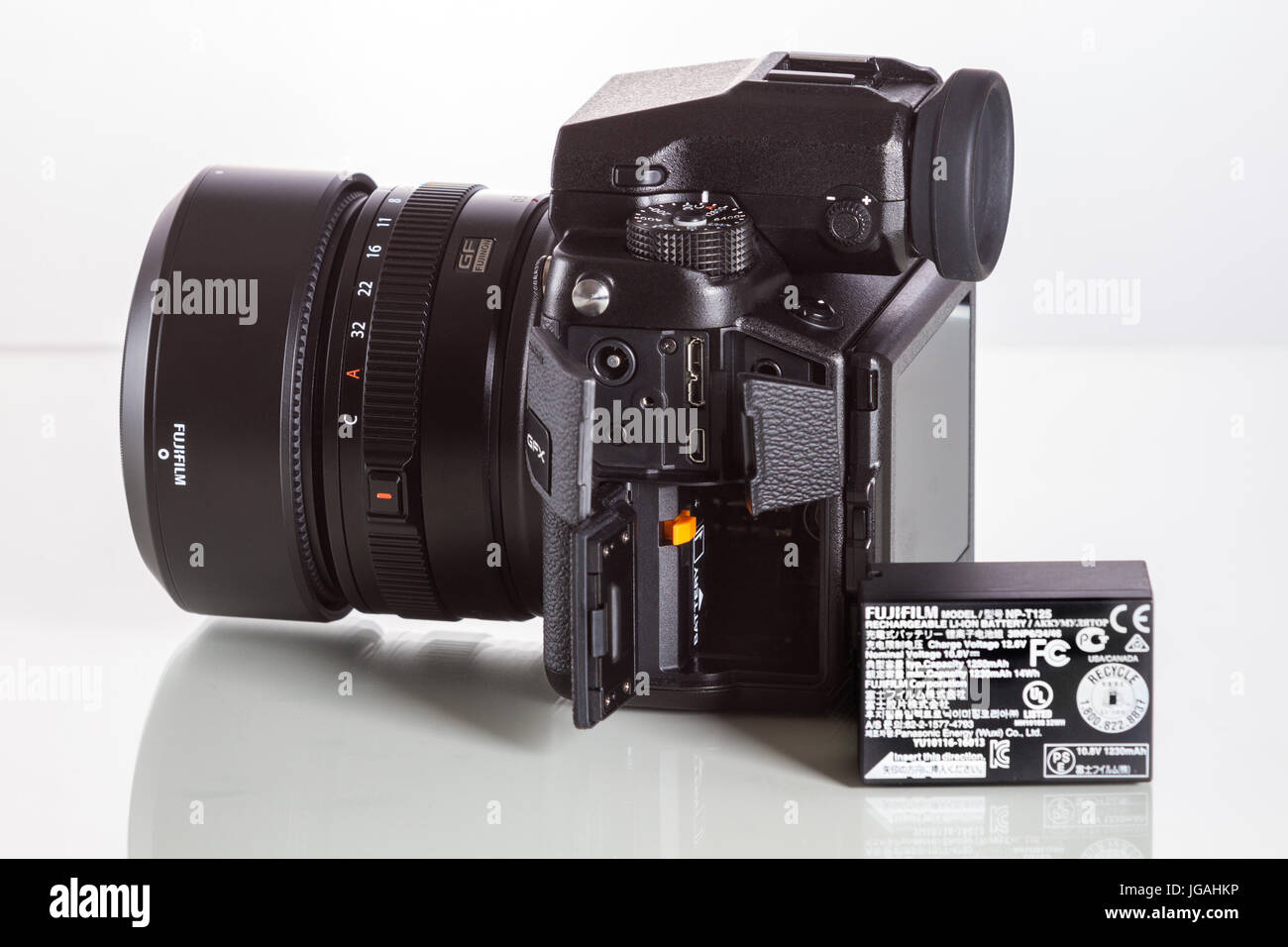 Fujifilm GFX 50S, 51 megapixels, medium format sensor digital camera with battery on white reflecting background Stock Photo