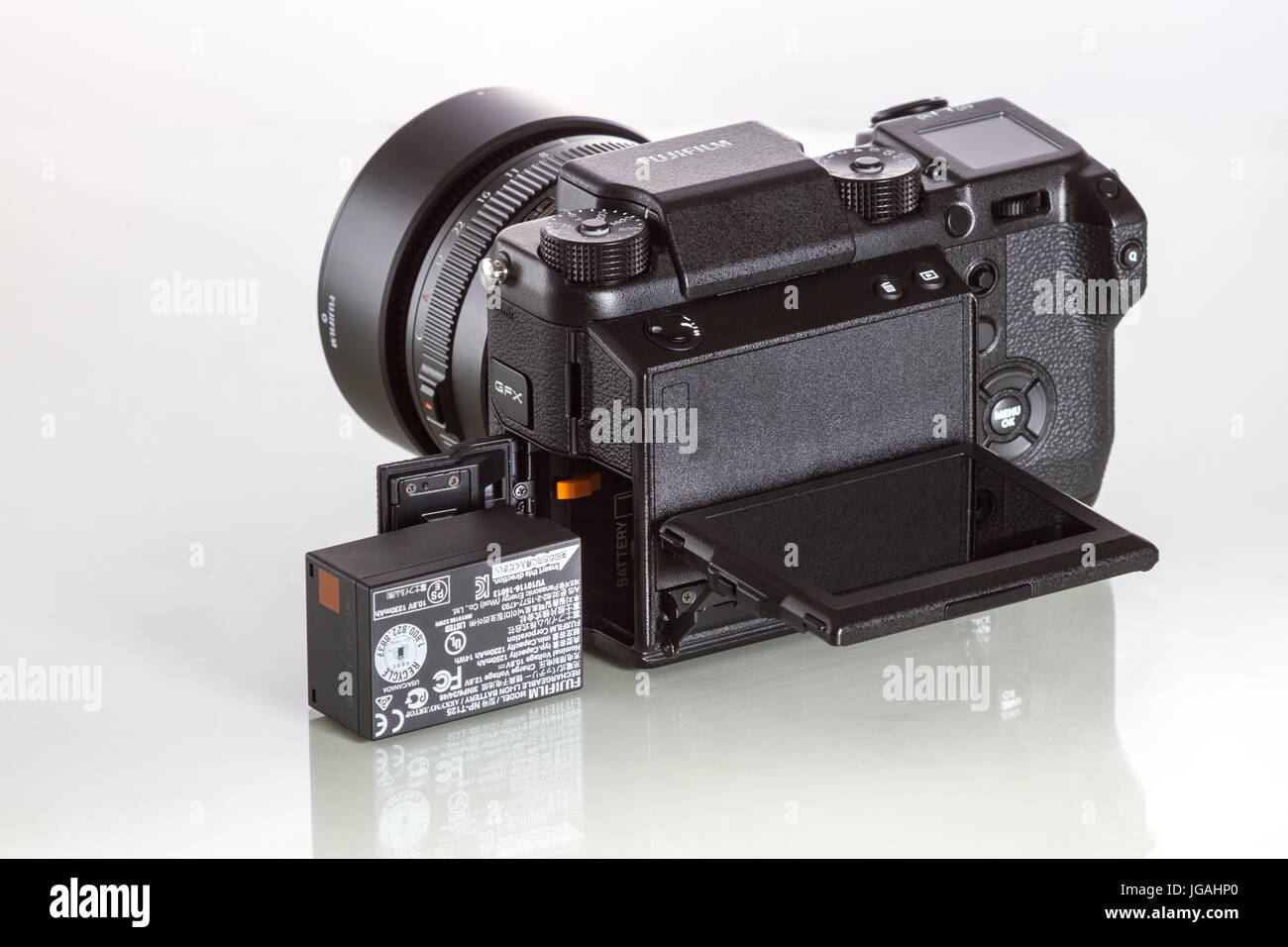 Fujifilm GFX 50S, 51 megapixels, medium format sensor digital camera with battery on white reflecting background Stock Photo