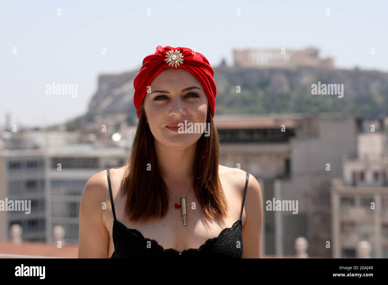 American singer, songwriter, burlesque performer, and comedienne, Ariana Savalas poses with Acropolis at the background. Ariana is on tour with 'Postm Stock Photo