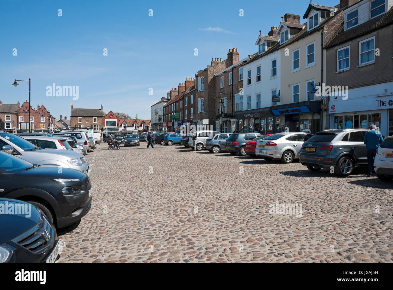 Cars parked in the town centre in spring Thirsk North Yorkshire England UK United Kingdom GB Great Britain Stock Photo
