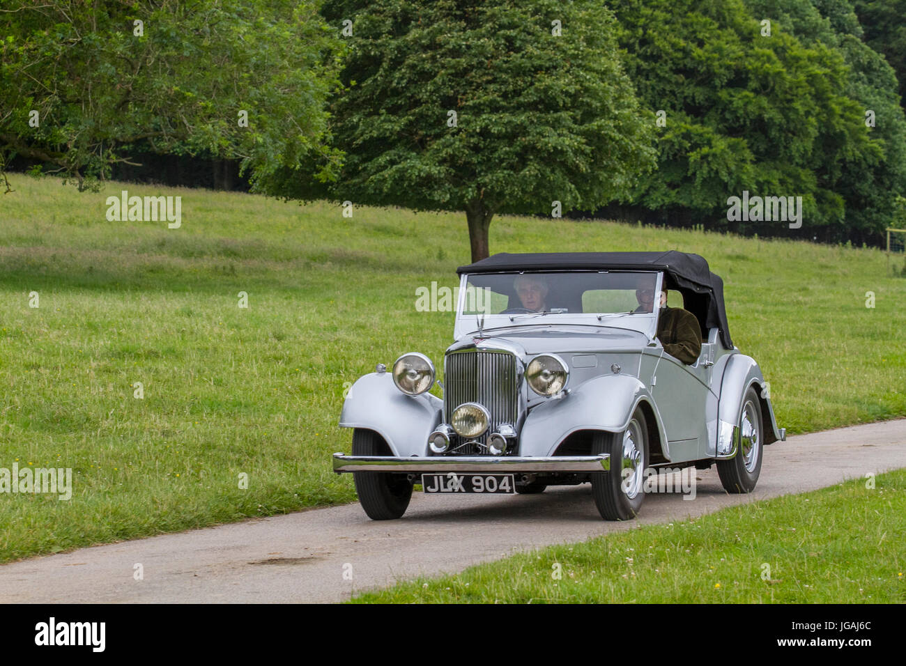 1948 40s Alvis Classic convertible, collectable restored vintage vehicles being driven in woodland park, UK Stock Photo