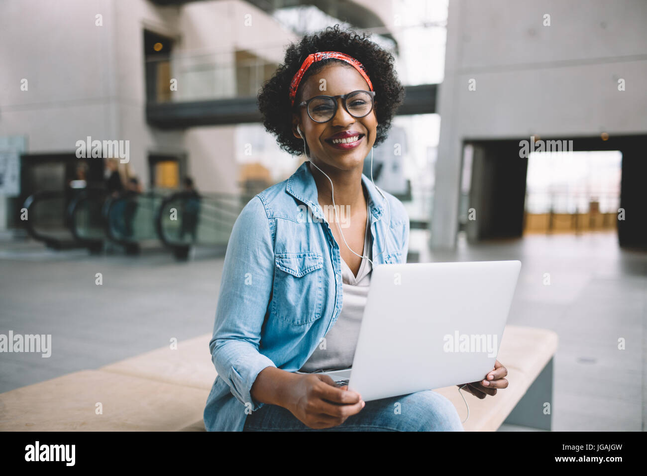 Young African female entrepreneur smiling confidently and working on a ...