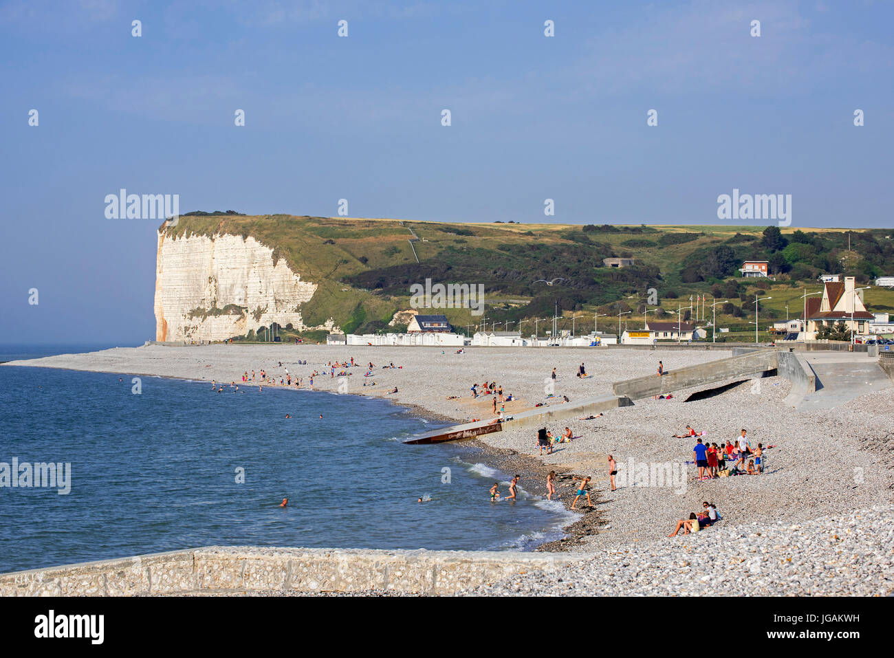White chalk cliffs and sunbathers on pebble beach at Veulettes-sur-Mer, Seine-Maritime, Normandy, France Stock Photo