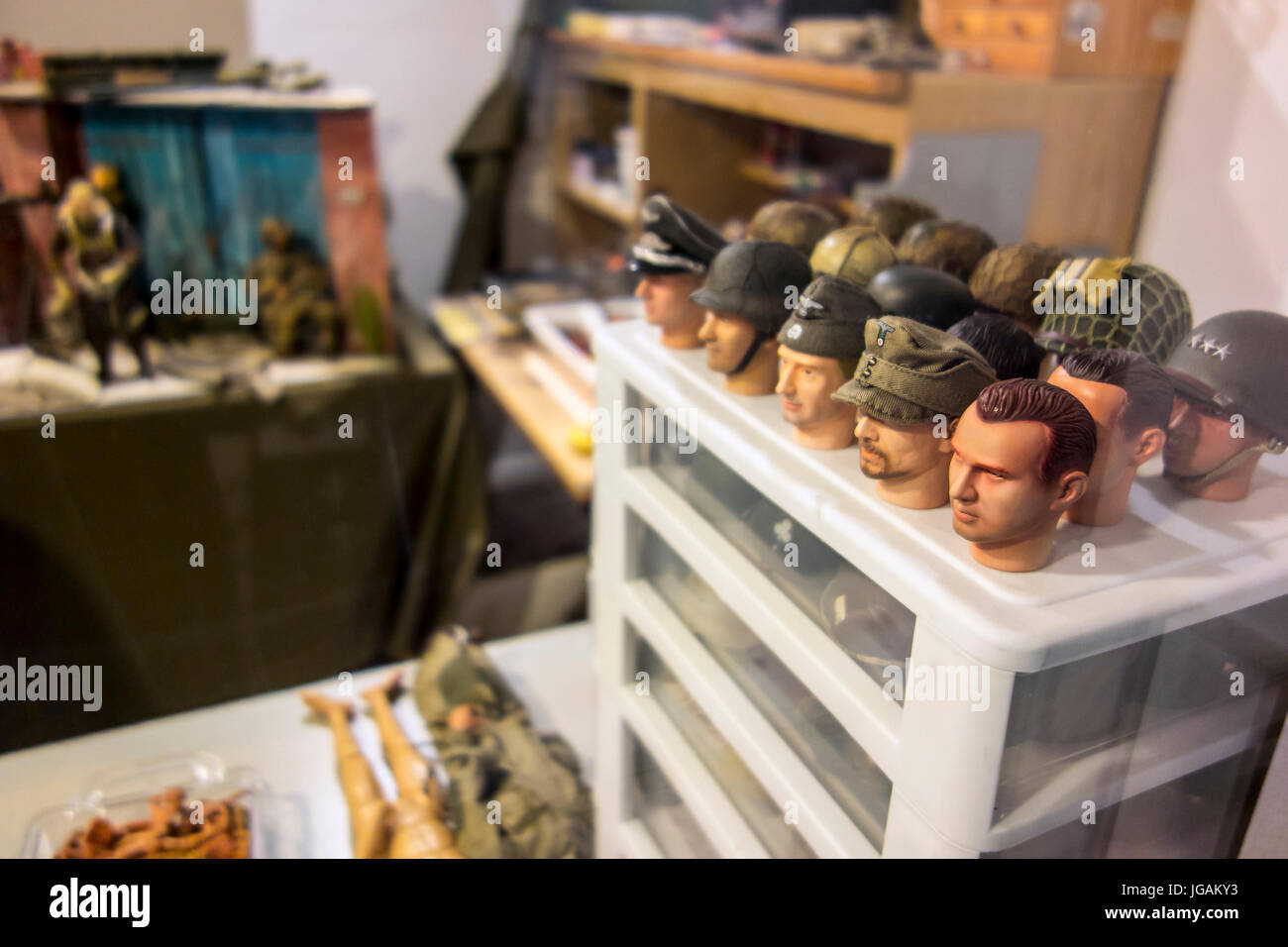Miniature heads of WW2 soldiers for making scale model battle scene dioramas in workshop Stock Photo