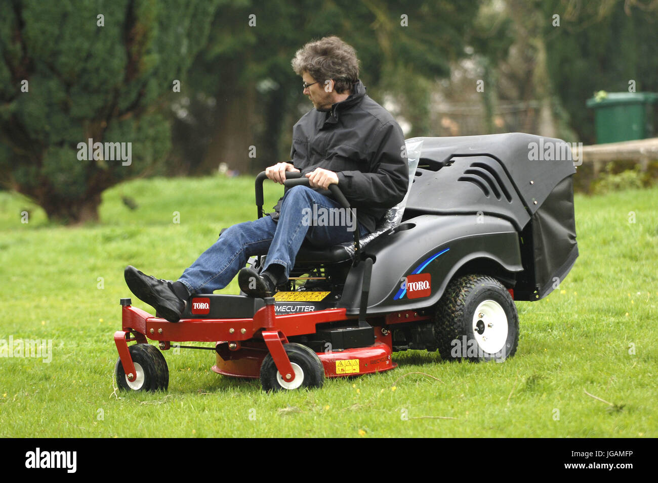 Siton mowers being used to cut grass Stock Photo Alamy