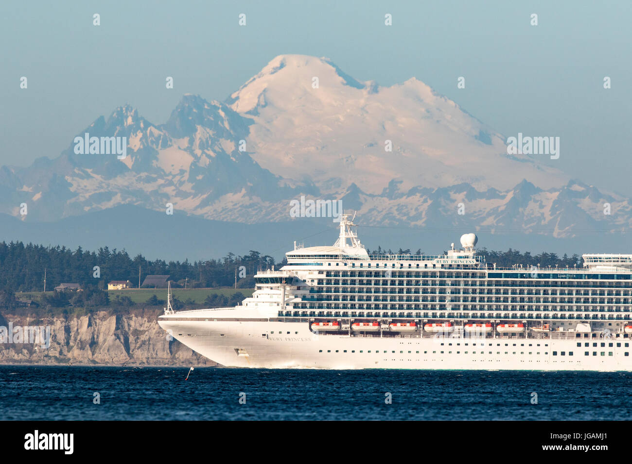 Cruise ship, cruise liner sails on Puget Sound past Mount Baker. Stock Photo