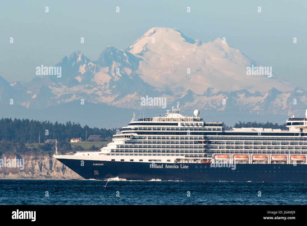 Cruise ship, cruise liner sails on Puget Sound past Mount Baker. Stock Photo