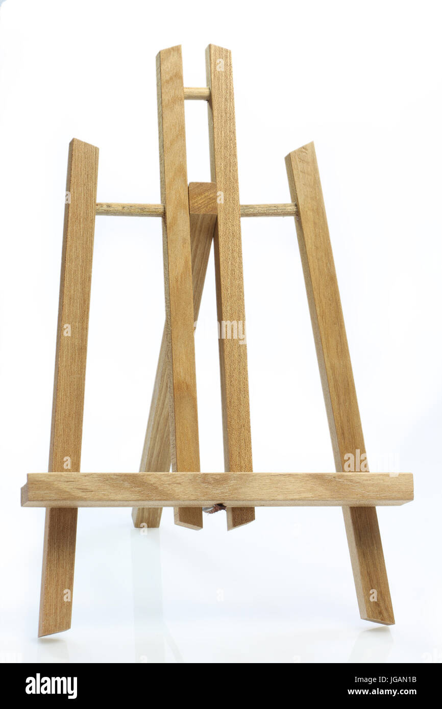 Wooden art easel on bright background Stock Photo Alamy