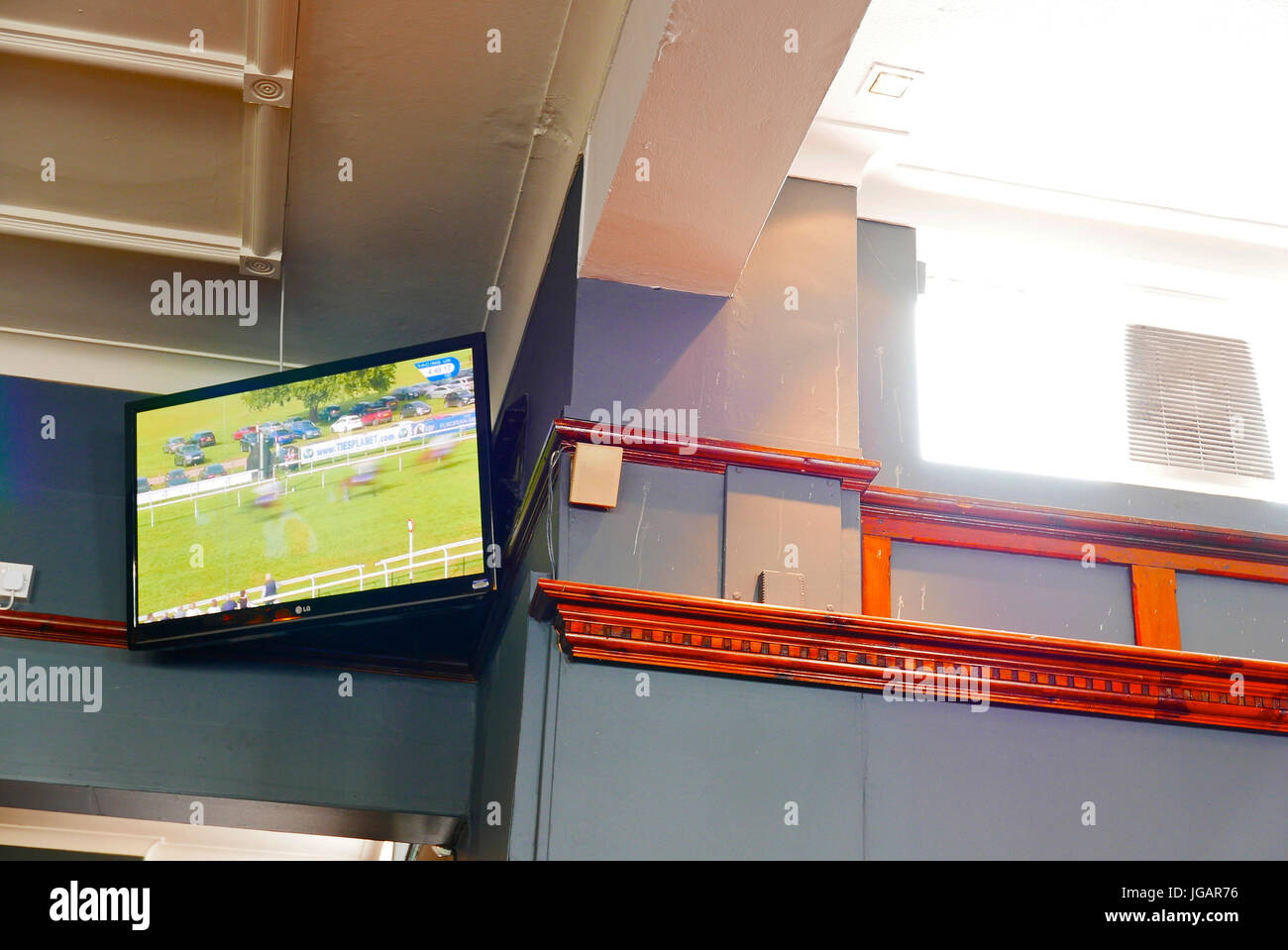 Horse racing showing on television in sports bar,Blackpool,Lancashire,UK Stock Photo