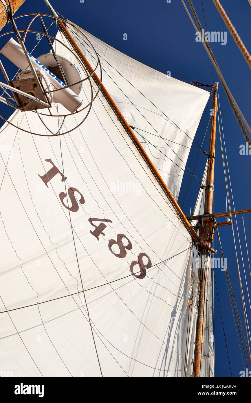 Astrid (Finland) TS 488 Gaff Ketch wooden sailing boat 1947 - view of the main sail and top sail looking up against the sky Stock Photo