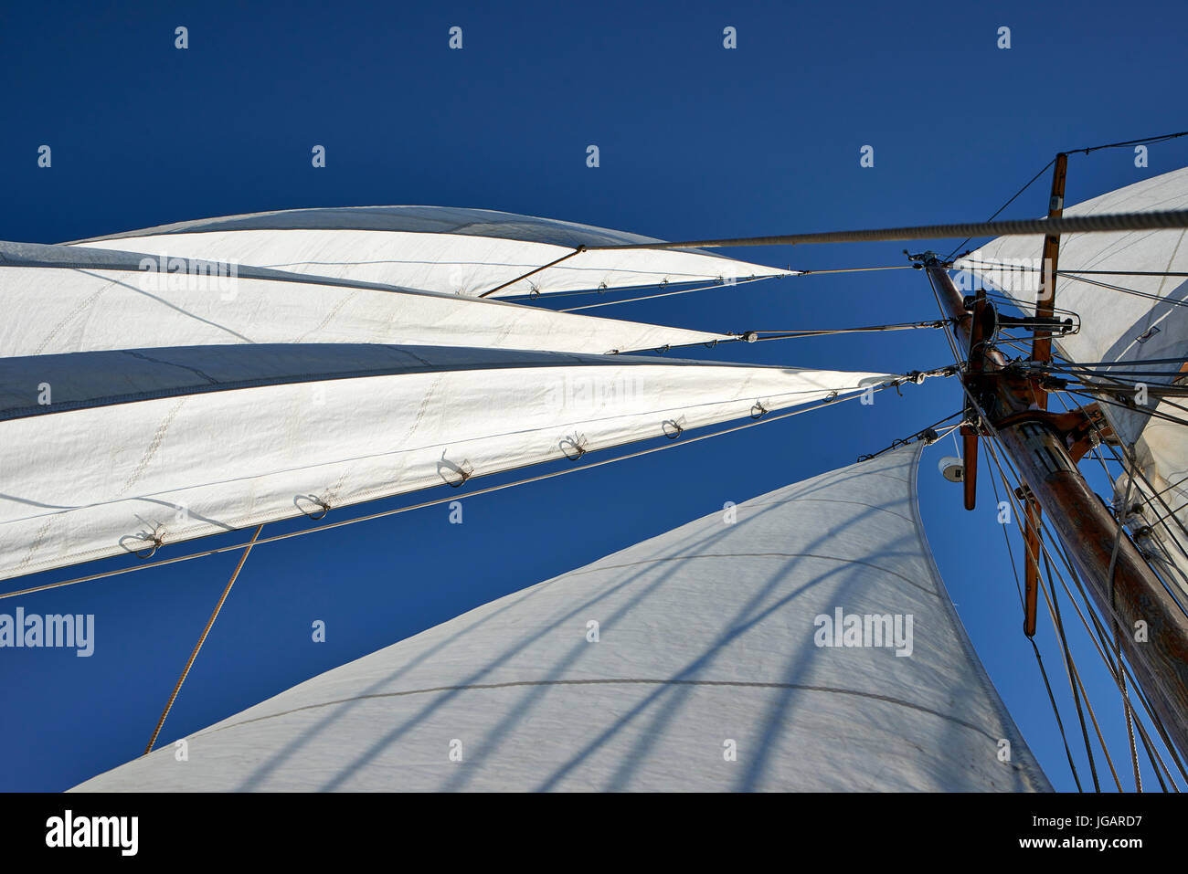Astrid (Finland) TS 488 Gaff Ketch wooden sailing boat 1947 - view of the main mast and sails looking up against the sky Stock Photo