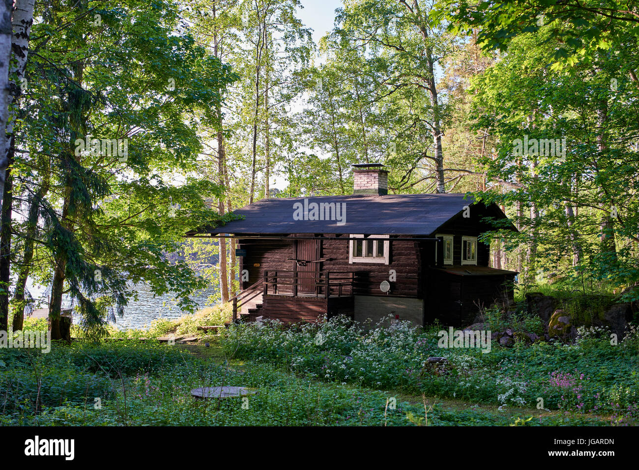 Wooden cabin in the woodland on Kotiluoto island in the Helsinki archipelago Stock Photo