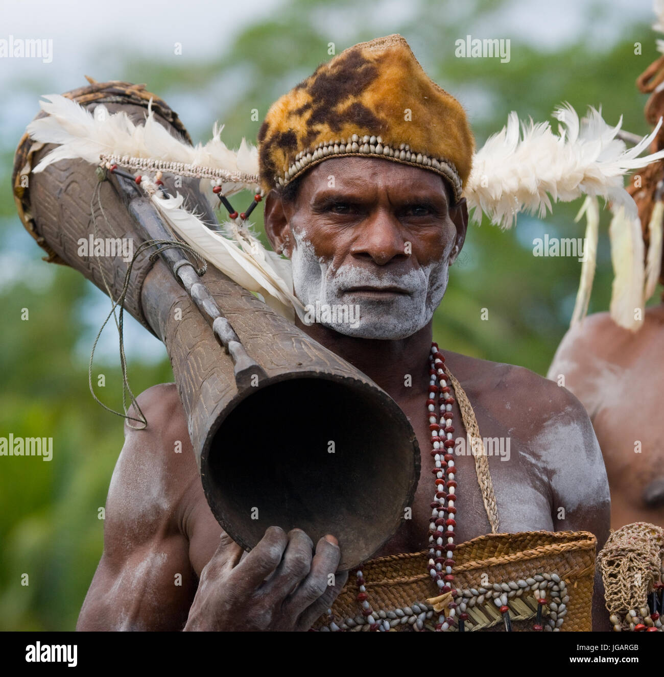 INDONESIA, IRIAN JAYA, ASMAT PROVINCE, JOW VILLAGE - JANUARY 19: Portrait Asmat warrior with a tribal ritual drum. Stock Photo
