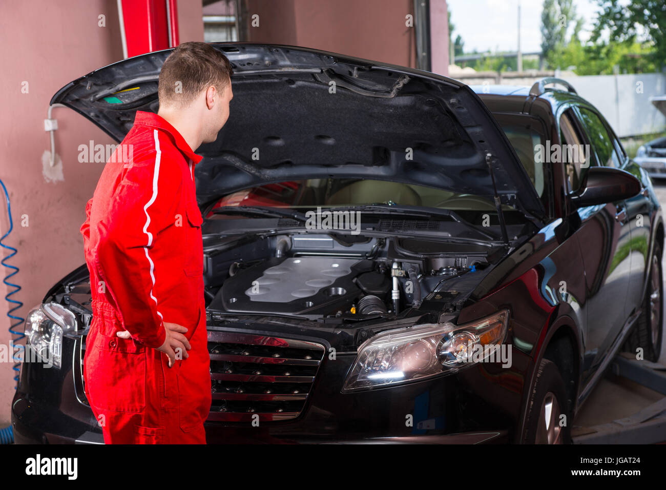 Mechanic in uniform standing hi-res stock photography and images - Alamy