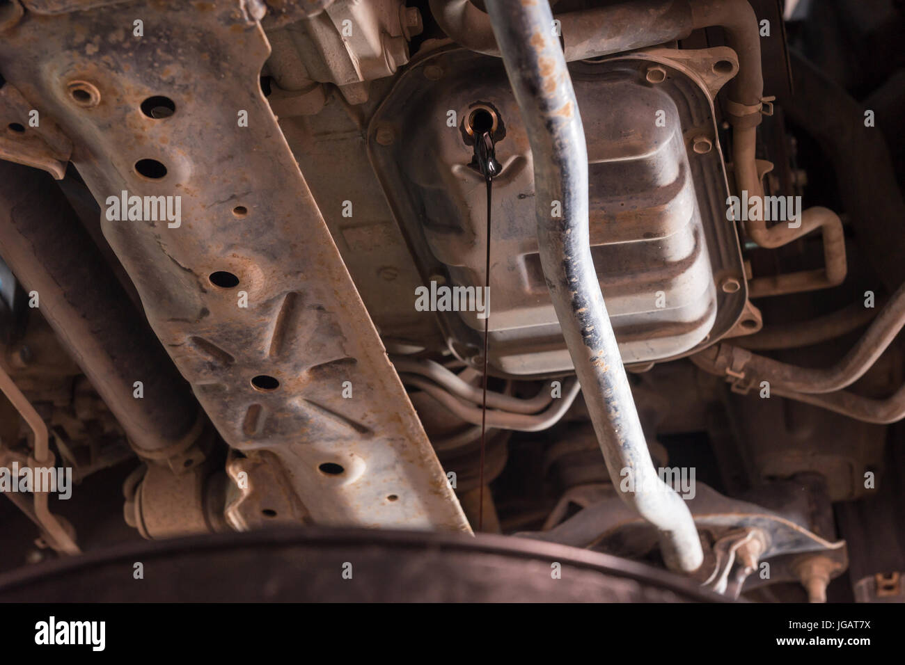 Oil flows out from automobile engine in a car workshop Stock Photo