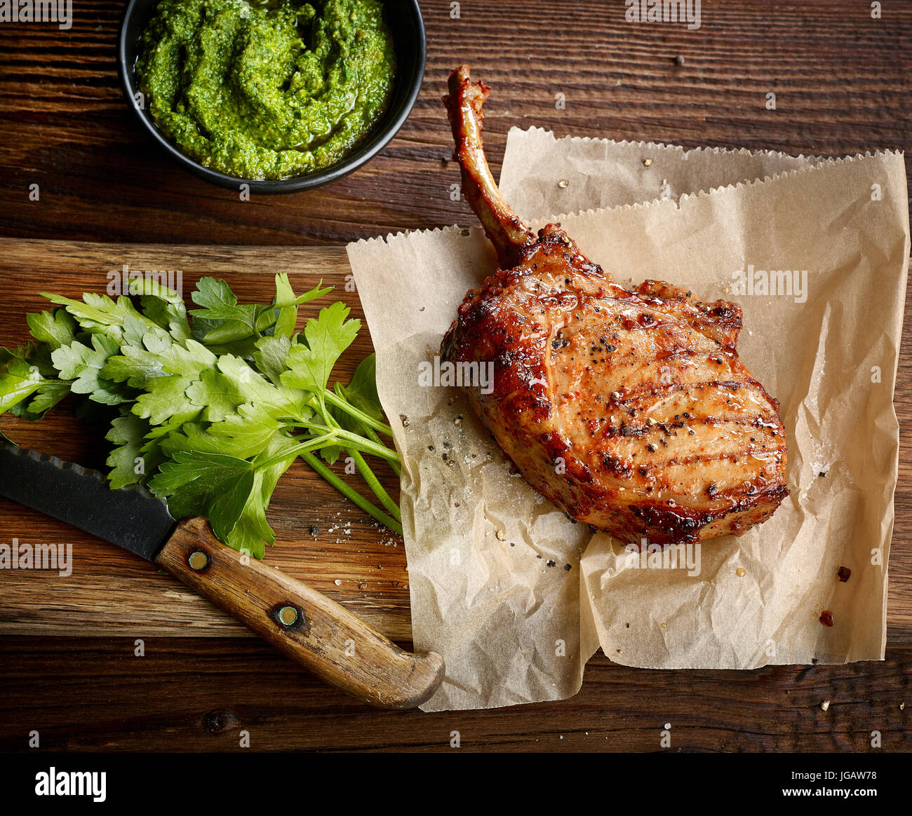 freshly grilled Tomahawk steak on wooden table, top view Stock Photo