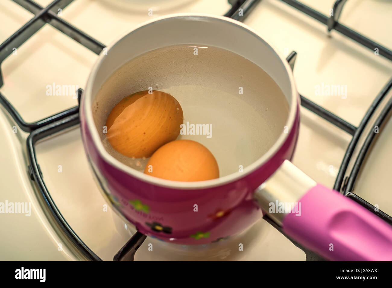 Boiling two eggs in water in stainless steel pan Stock Photo Alamy