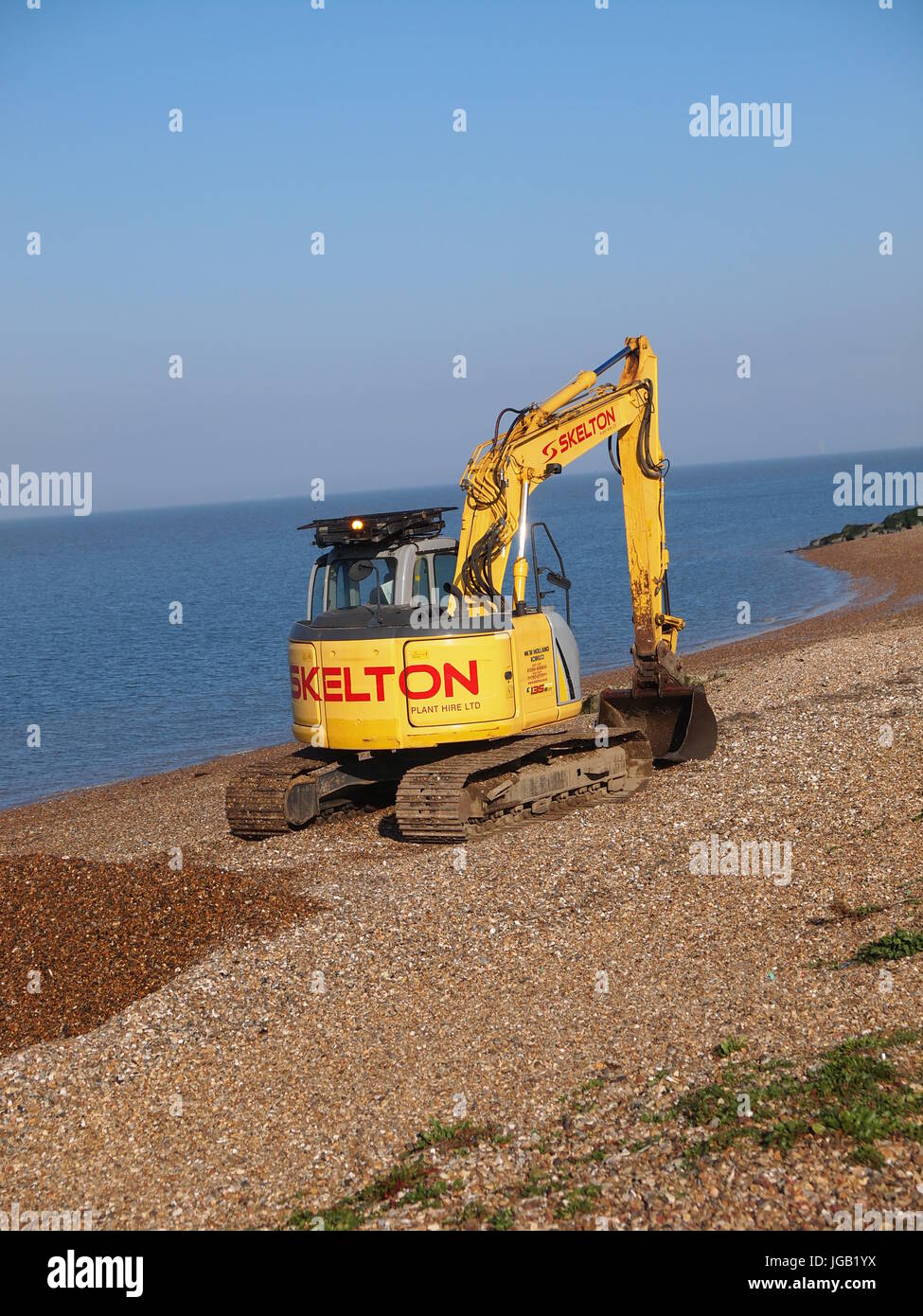 Excavator on a beach hires stock photography and images Alamy