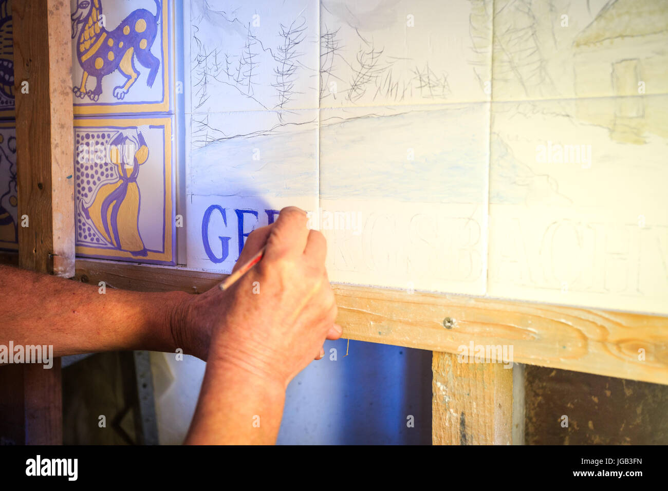 Painting traditional portuguese tiles called azulejos in Silves, Algarve, Portugal Stock Photo