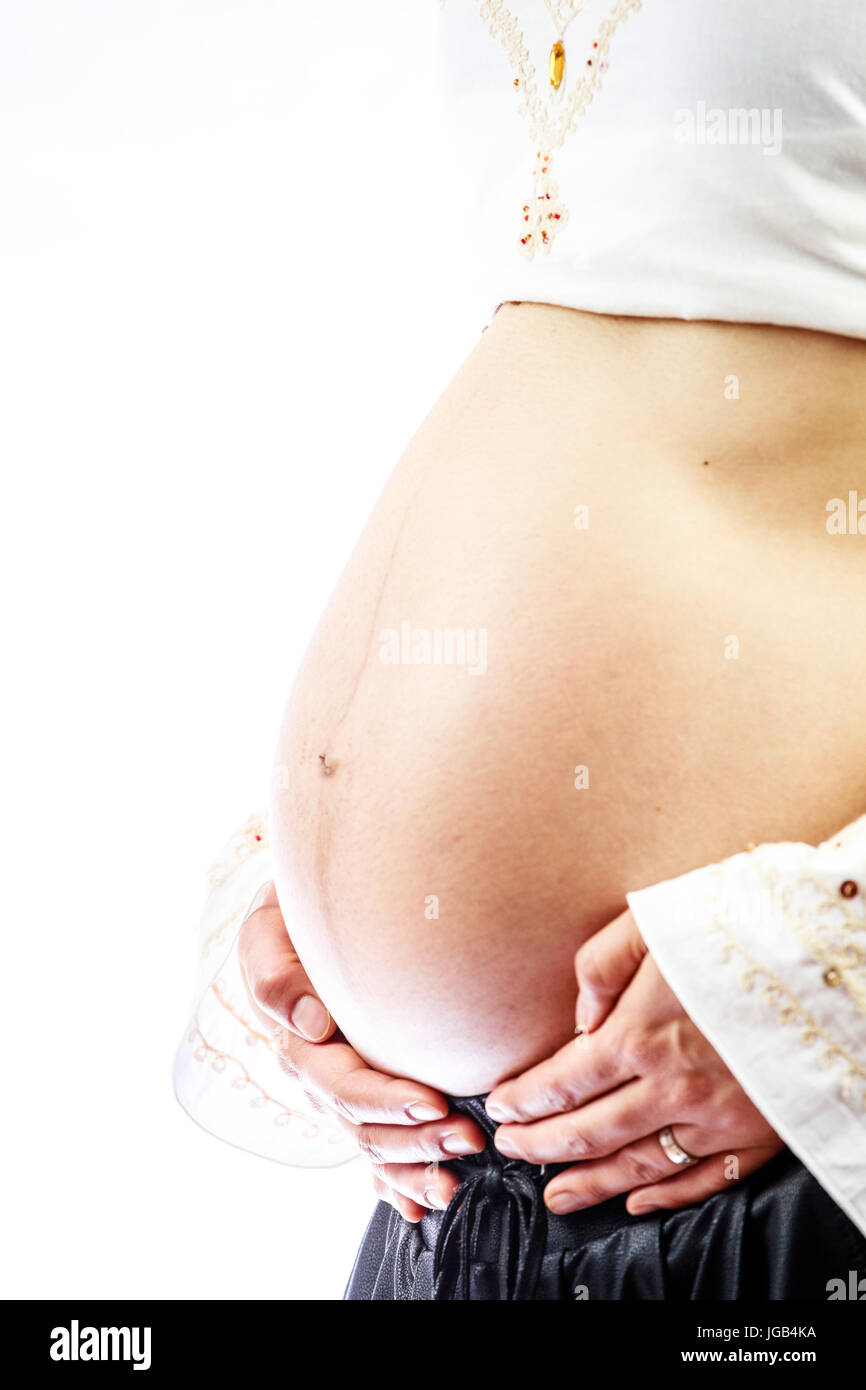 Pregnant woman with hands on her big belly Stock Photo