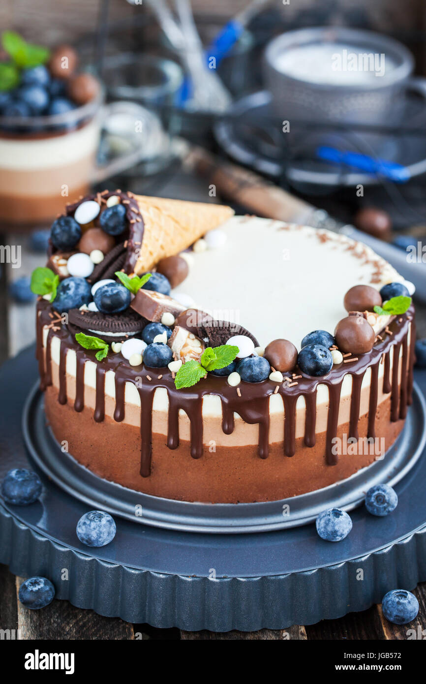 Delicious Three Chocolate Mousse Cake Decorated With Waffle Cone Fresh Blueberry Mint Candies And Frosting Stock Photo Alamy