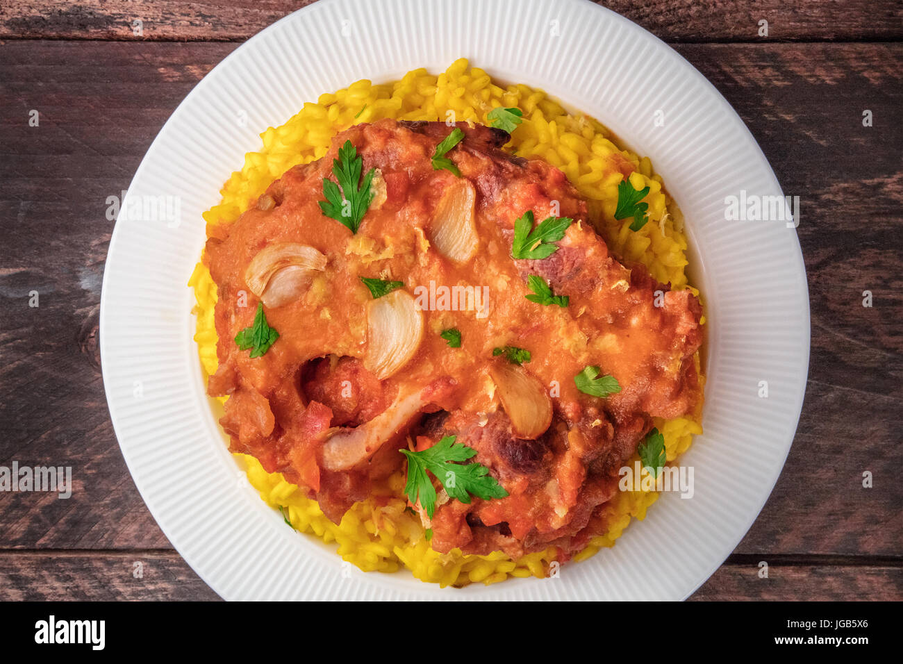 Ossobuco with risotto alla milanese and gremolata Stock Photo Alamy