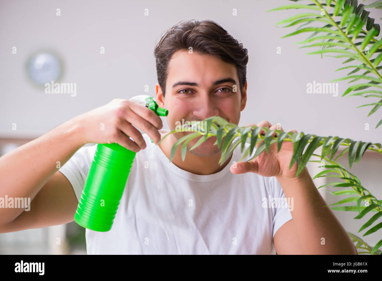 Young man in gardening concept at home Stock Photo