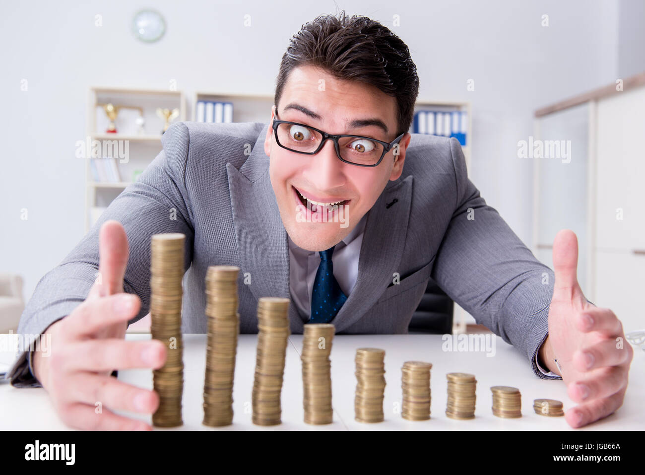 Businessman with golden coins in business growth concept Stock Photo ...