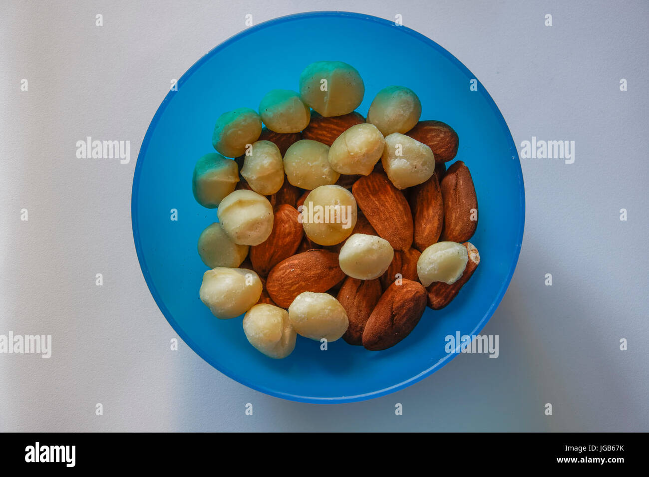 Macadamia and almonds mixed roasted nuts top closeup view. Collection