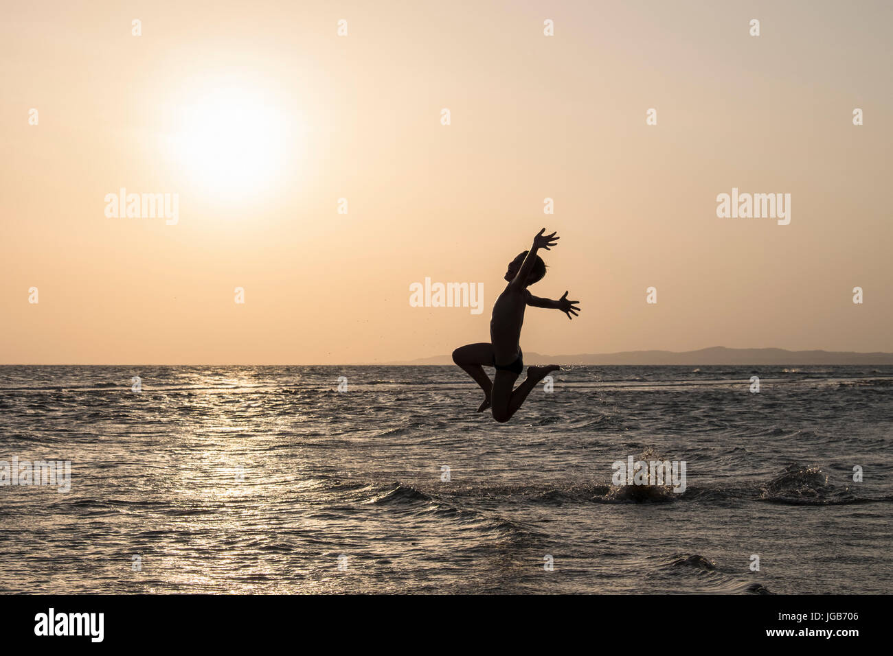 Boy running with joy on the water. Stock Photo