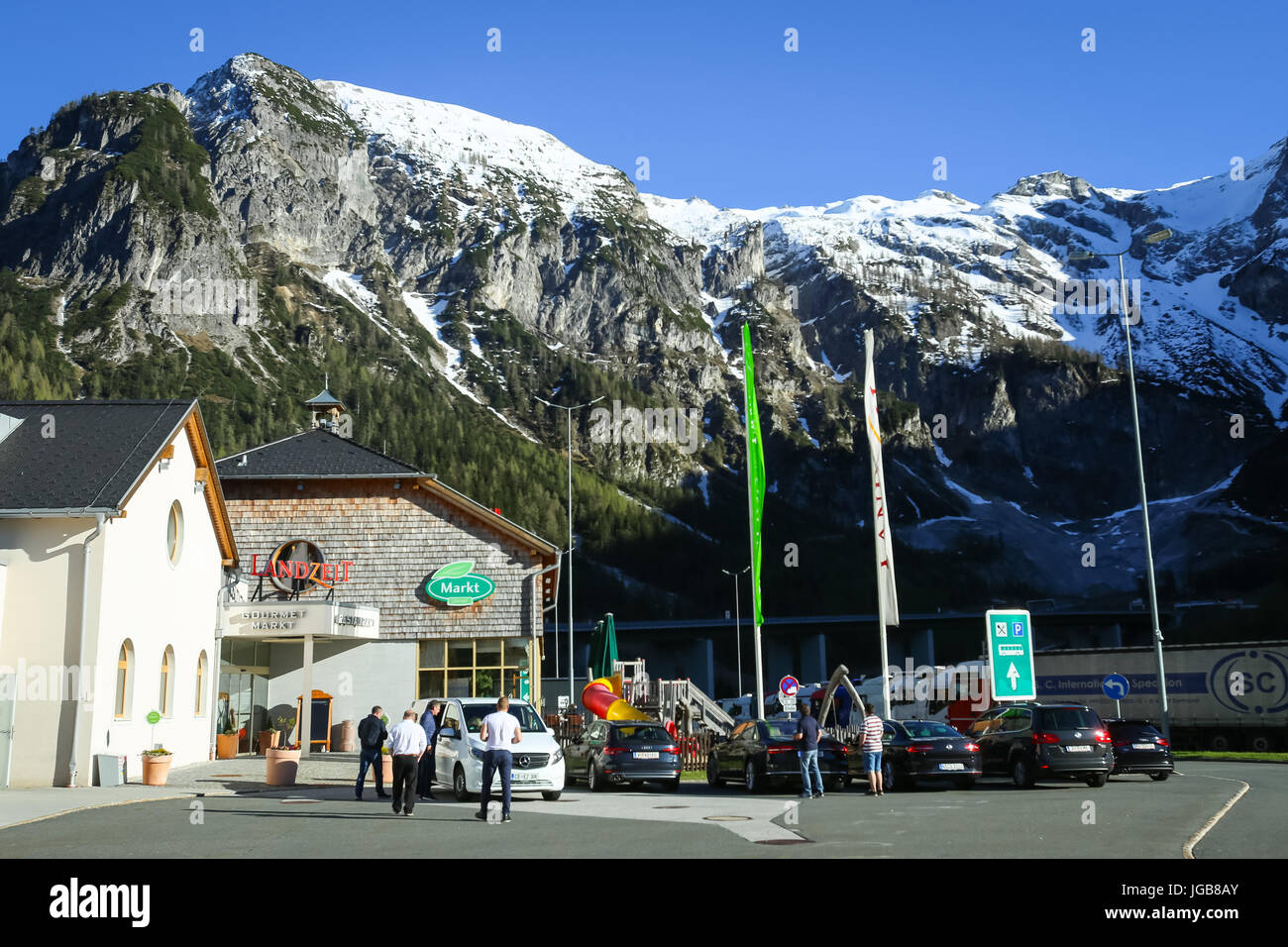 FLACHAU, AUSTRIA - MAY 10, 2017 : People at the highway rest stop with the Landzeit Tauernalm hotel and restaurant in Alps environment in Flachau, Aus Stock Photo