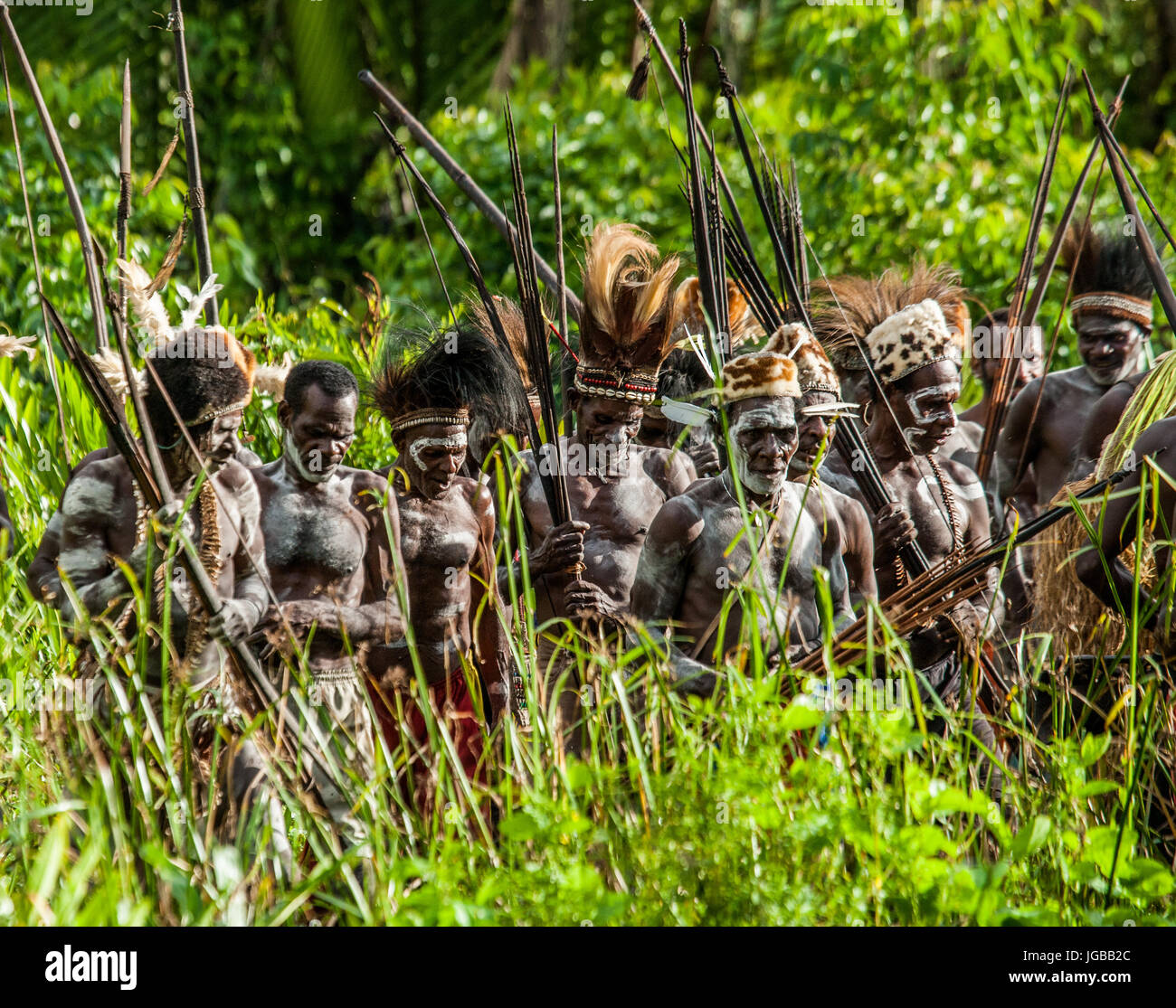 INDONESIA, IRIAN JAYA, ASMAT PROVINCE, JOW VILLAGE - JUNE 12: Asmat tribe warrior with bow and arrow. Stock Photo