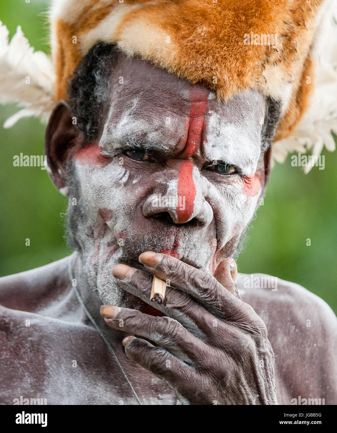 INDONESIA, IRIAN JAYA, ASMAT PROVINCE, JOW VILLAGE - JUNE 12: The Portrait Asmat warrior with a traditional painting and coloring on a face. Stock Photo