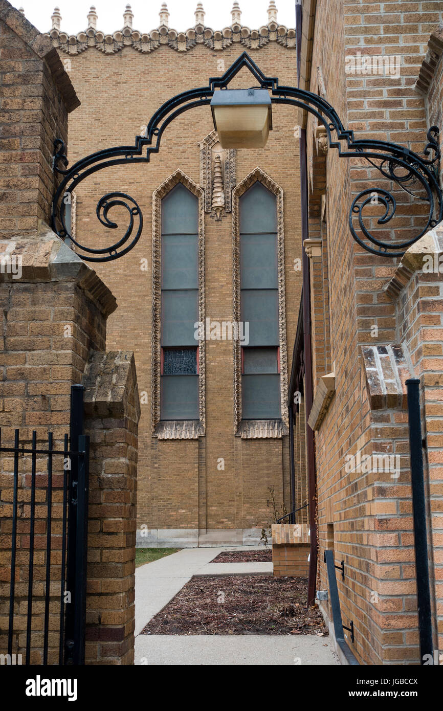 Decorative wrought iron archway above entrance to church yard Stock Photo