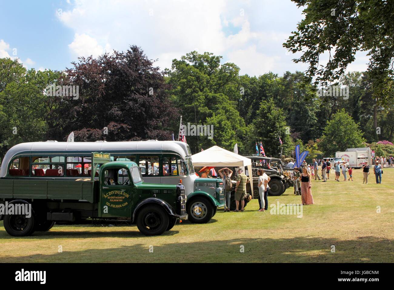 Sandhurst, UK - June 18 2017: Vintage truck, bus and military vehicles at a car show with enthusiasts in background Stock Photo