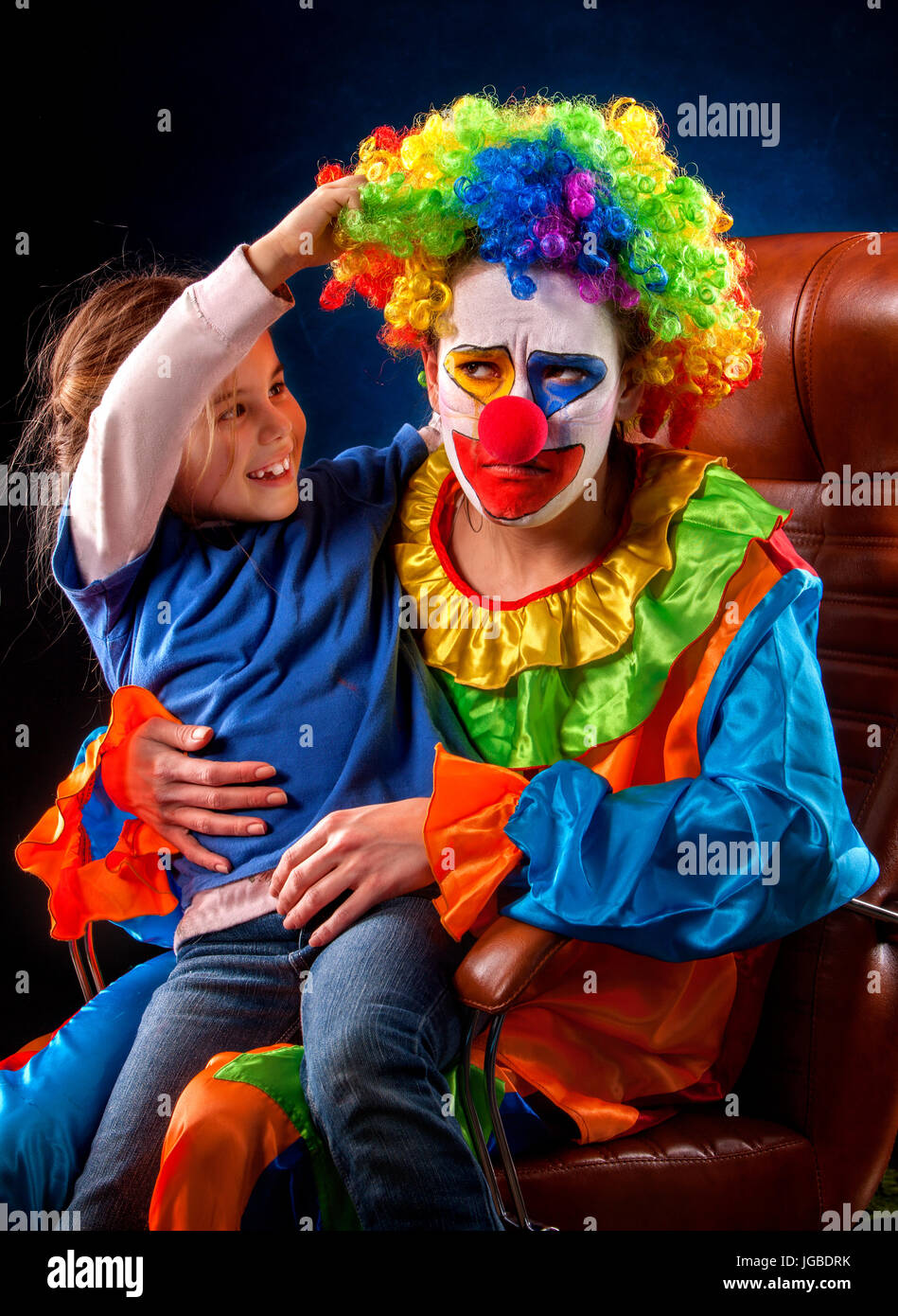 Single parent family. Mom after work birthday clown. Adult child relationship. Stock Photo