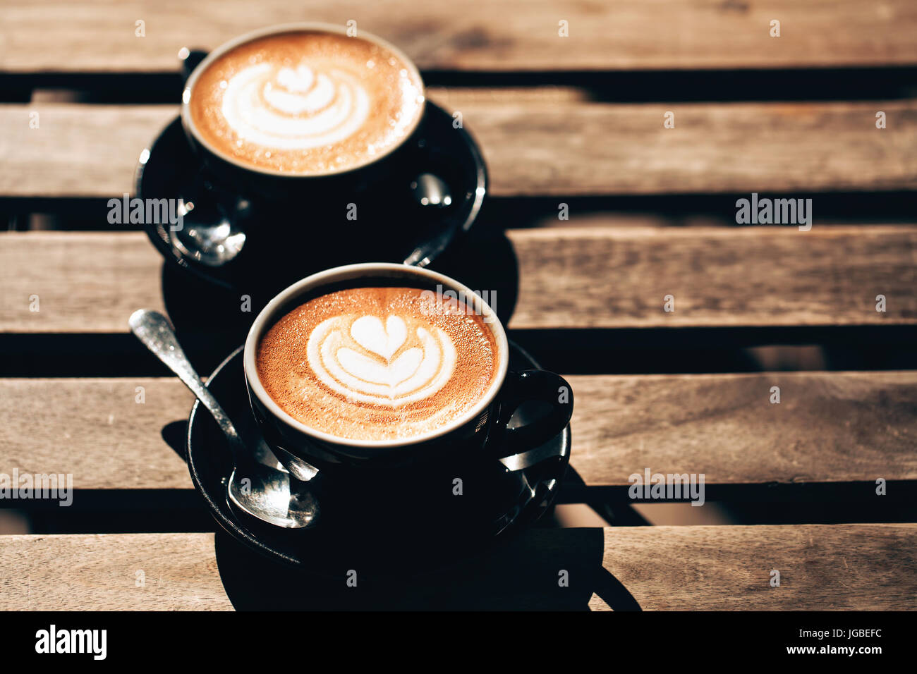 Two cups of cappuccino with latte art Stock Photo Alamy