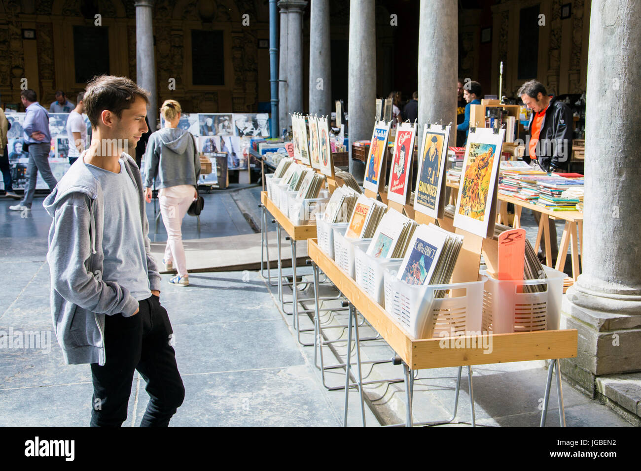 Man looking at old prints in the market in La Vieille Bourse (Old Stock Exchange) in Lille, France Stock Photo