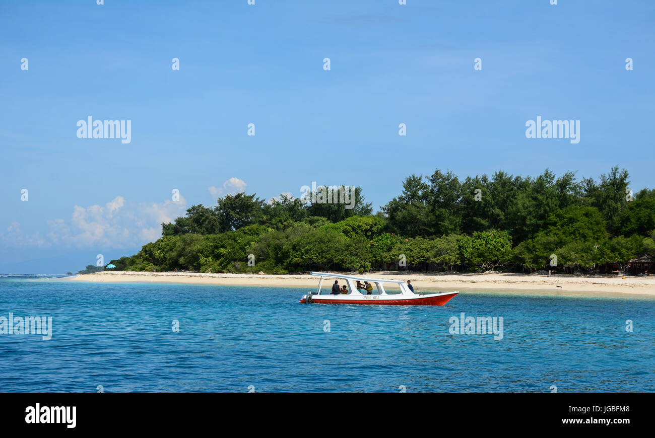 Bali, Indonesia - Apr 18, 2016. A wooden boat with white beach in Bali Island, Indonesia. Bali is part of the Coral Triangle, the area with the highes Stock Photo