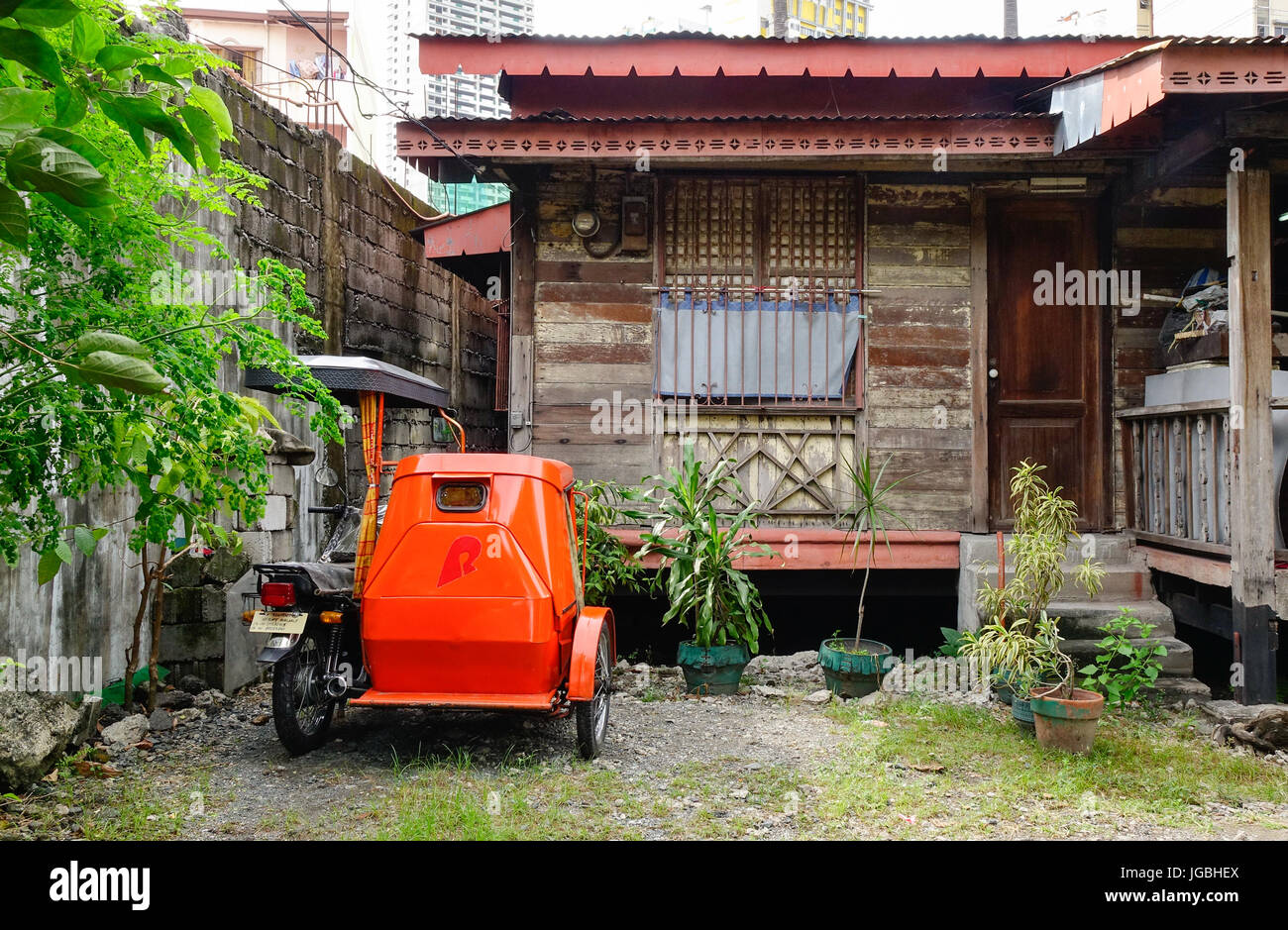 Manila, Philippines Dec 20, 2015. A tricycle with house at slum