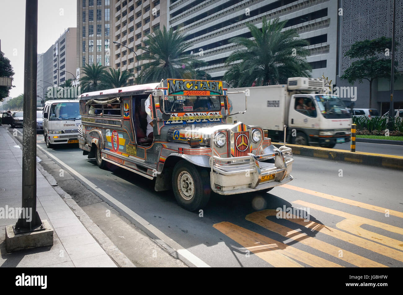 Manila, Philippines - Dec 21, 2015. Jeepney running on Ayala street in Manila, Philippines. Jeepney is a most popular public transport on Philippines. Stock Photo