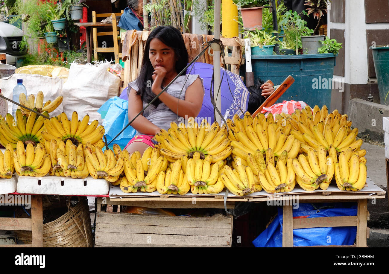 Manila, Philippines Dec 20, 2015. A little girl selling fruits on