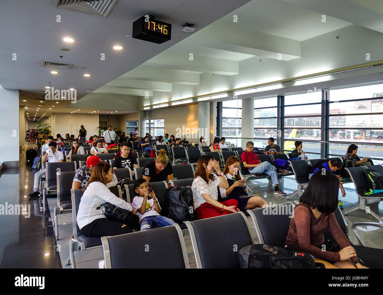 Manila, Philippines - Apr 14, 2017. People waiting at Terminal 3 of Ninoy Aquino Airport (NAIA) in Manila, Philippines. NAIA is the main intl gateway  Stock Photo
