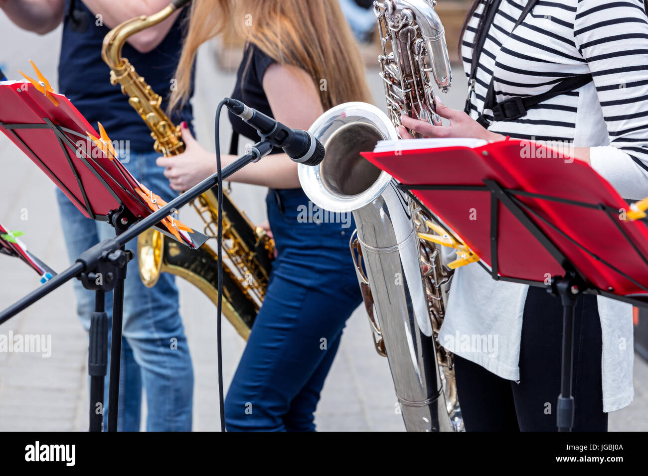 band of young saxophone players performing during music fest in the