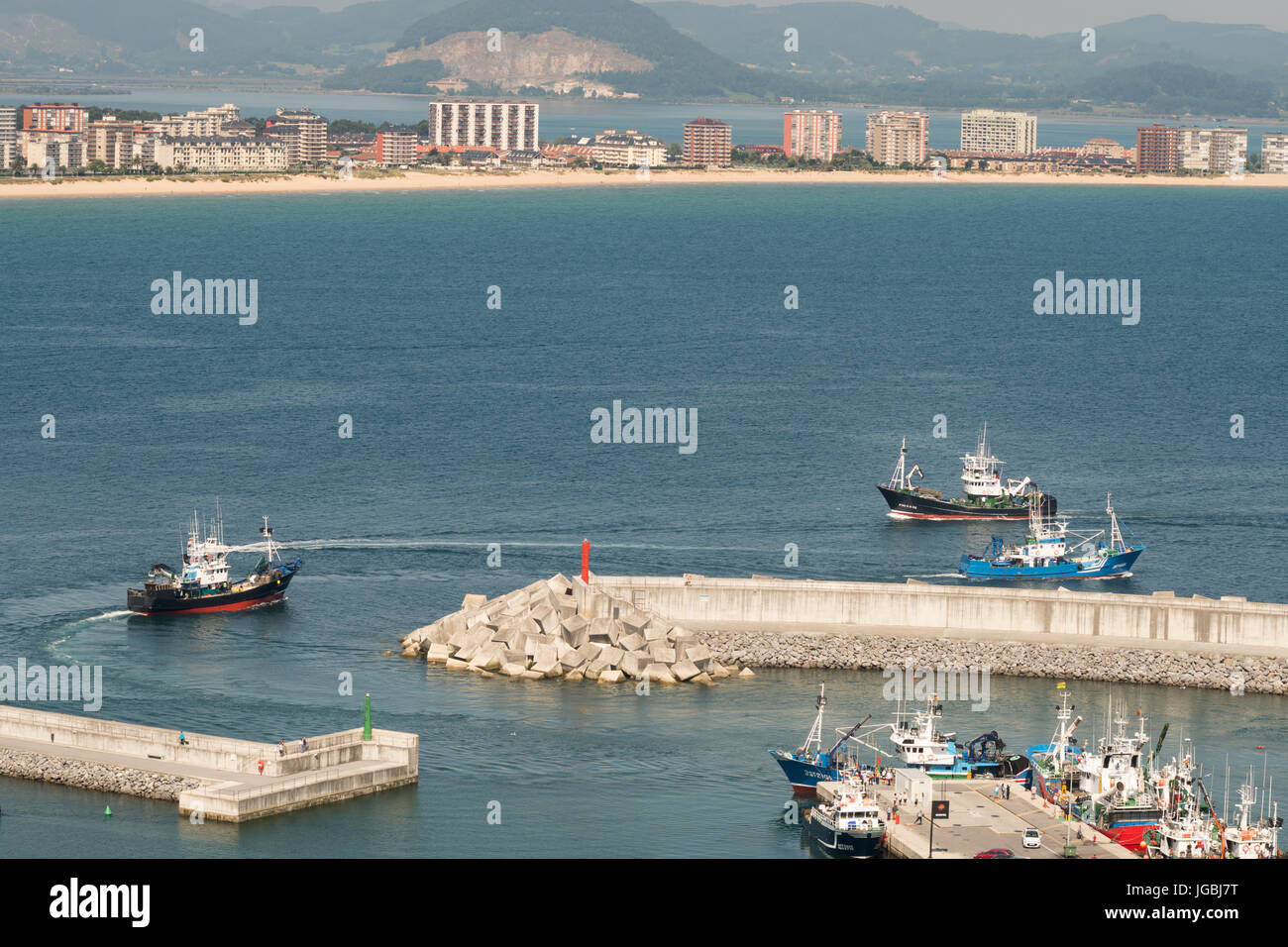 Fishing boats negotiating harbour mouth, Laredo, Cantabria, Spain Stock Photo