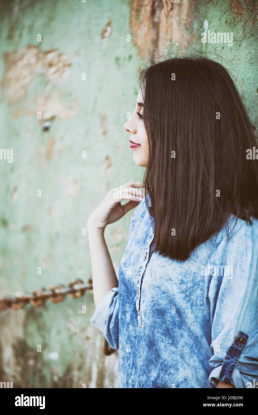 Side view of a young woman standing outdoors looking away Stock Photo