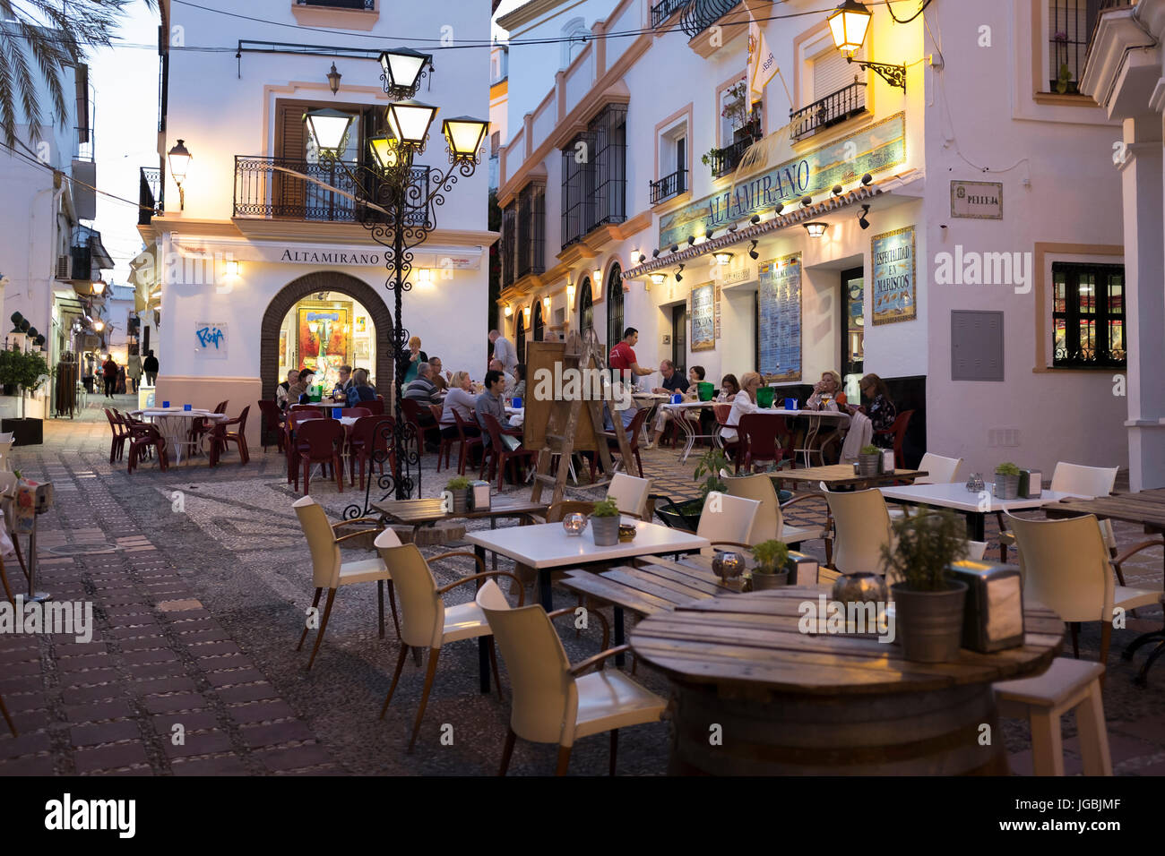 Restaurants in the small square of Calle Mendoza on a late spring evening in Marbella, Spain. Stock Photo