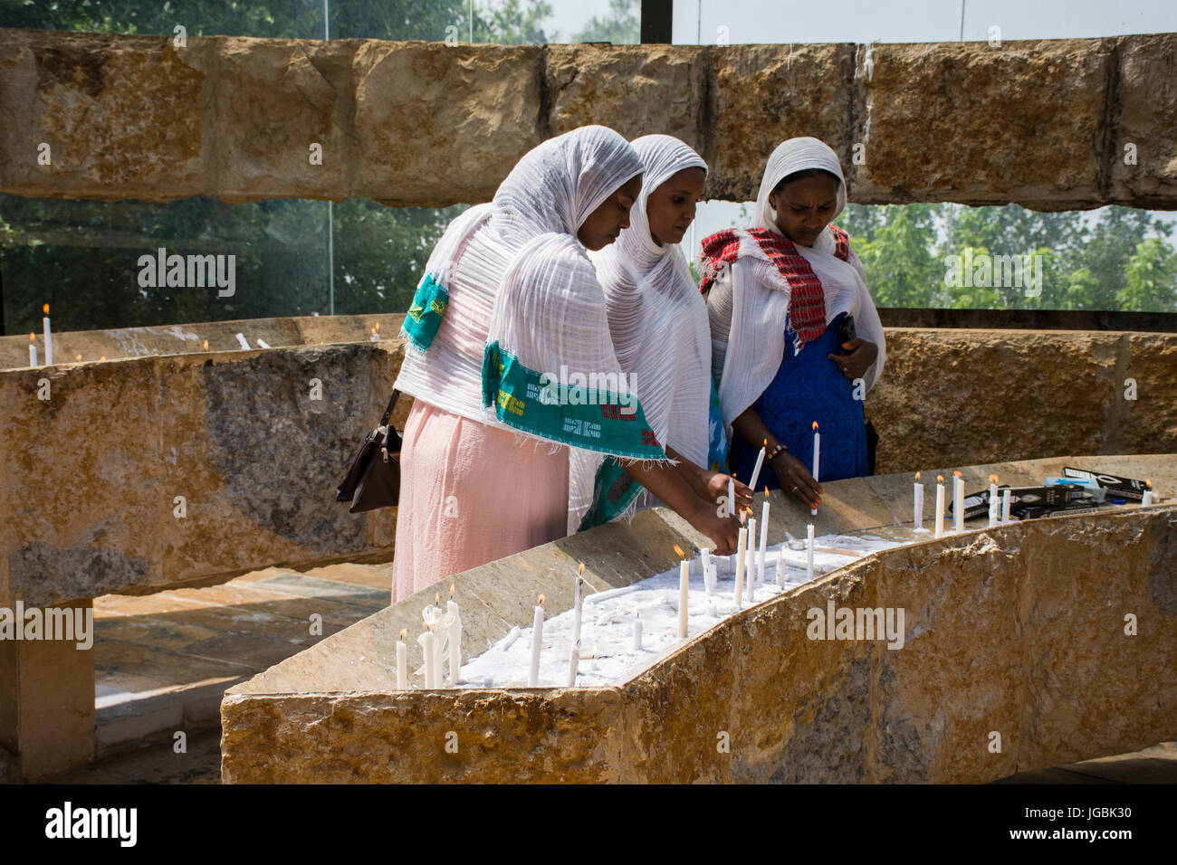 Ethiopian Orthodox Christian women on the St Yared day lighting candles outside Our Lady of Lebanon Church Stock Photo