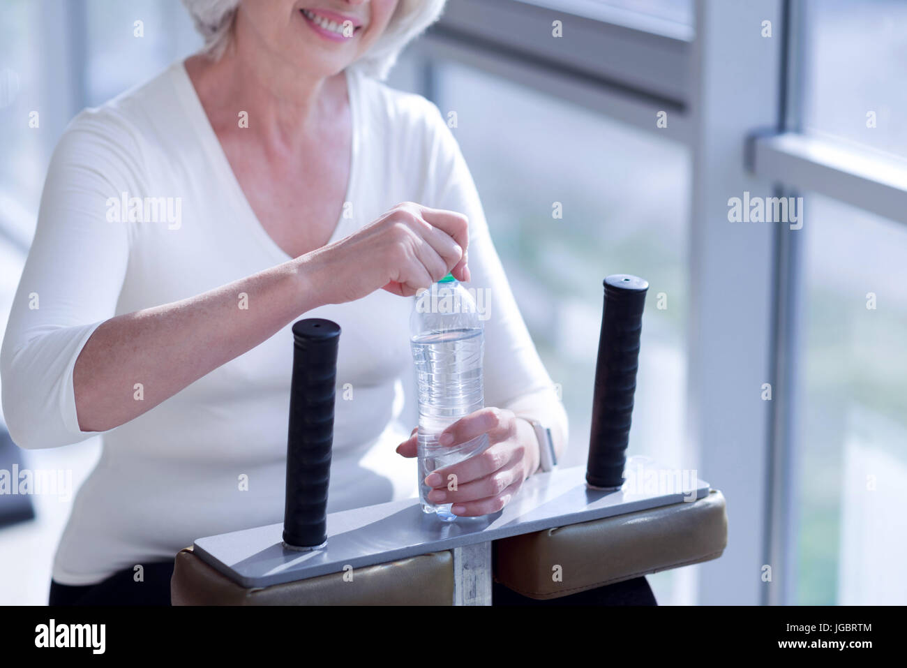 Closeup of elderly woman holding water bottle at gym Stock Photo - Alamy
